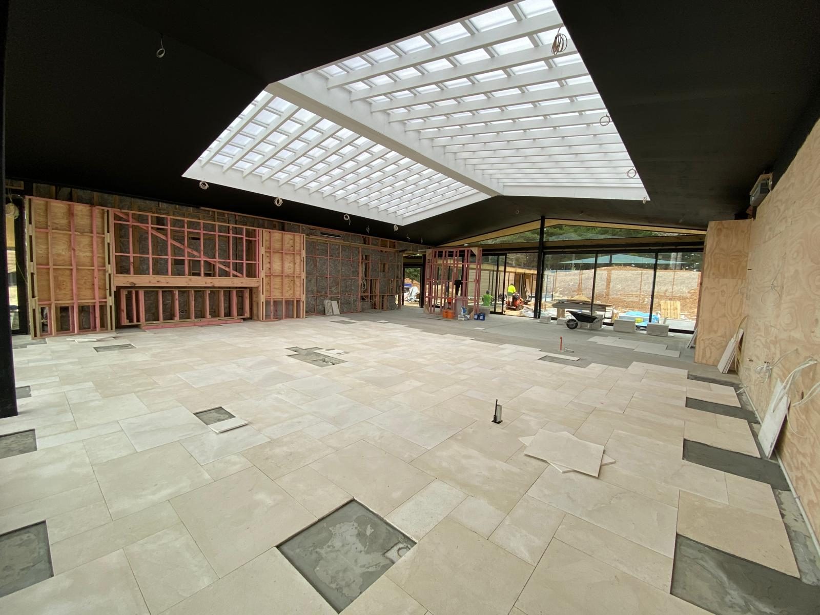 Large stone floor tiles laid through an architectural new build