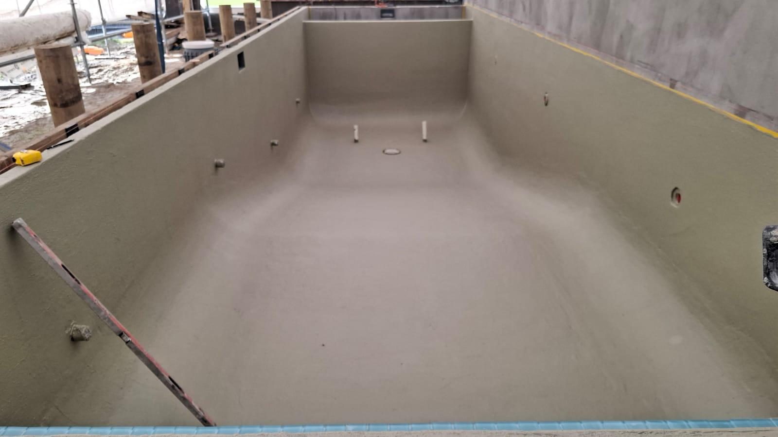 Swimming pool shell rendered and prepared for immersion service