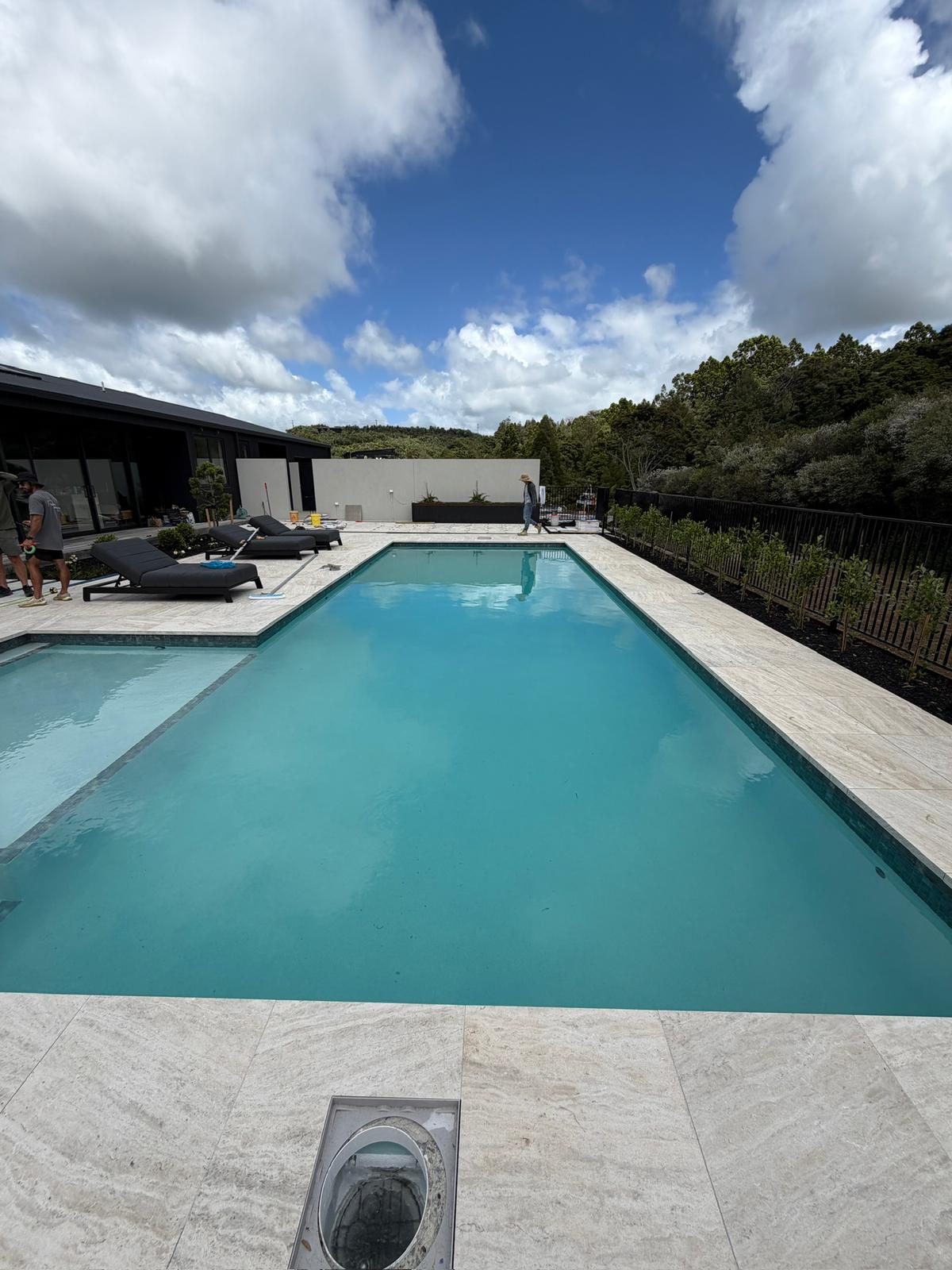 Finished swimming pool and spa with travertine surrounds