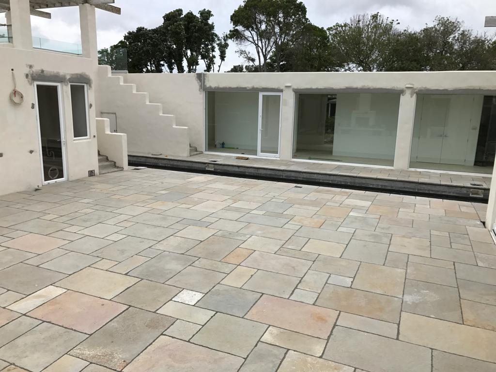 Sandstone patio paving in a coastal courtyard